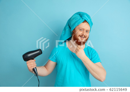 Portrait of young caucasian man in his beauty day and skin care routine 62115649