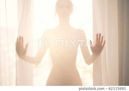 Defocus. High key light silhouette of a beautiful Defocus. High key light silhouette of a beautiful 62115691