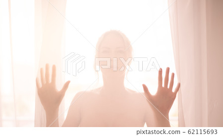 Defocus. High key light silhouette of a beautiful Defocus. High key light silhouette of a beautiful 62115693