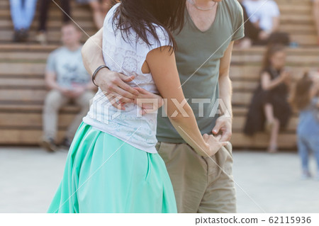 Kizomba, bachata or salsa concept - beauty couple dancing social dance on open air party. 62115936