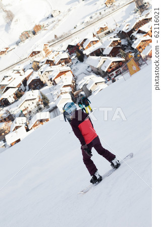 Snowboarders on snowy ski slope in high winter 62116021