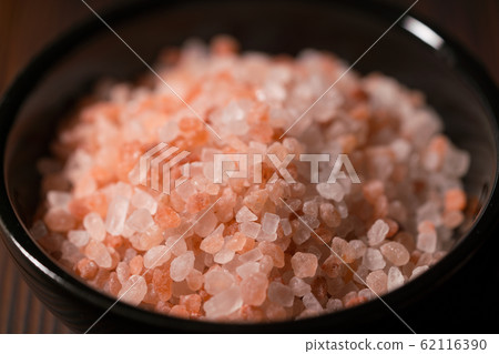 bowl of pink himalayan salt on dark wooden table bowl of pink himalayan salt on dark wooden table 62116390