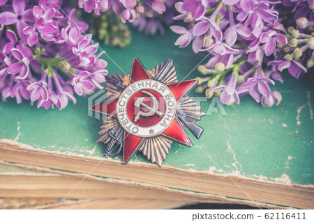 The Soviet order of the Second World war on natural moss background witj lilac branch, Victory Day 9 May 62116411