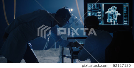 Astronaut and scientists testing spacesuit mobility 62117120