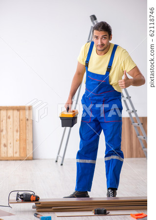Young male contractor working indoors 62118746