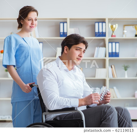 Disabled patient on wheelchair visiting doctor for regular check Disabled patient on wheelchair visiting doctor for regular check 62119013