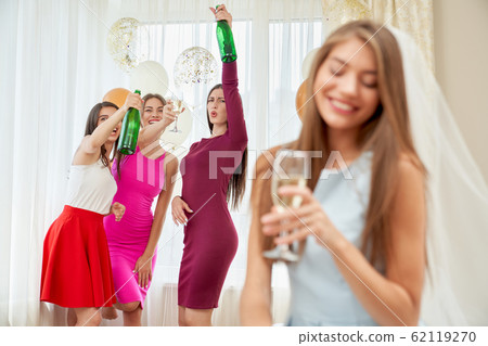 Bridesmaids having fun at bachelorette party. 62119270