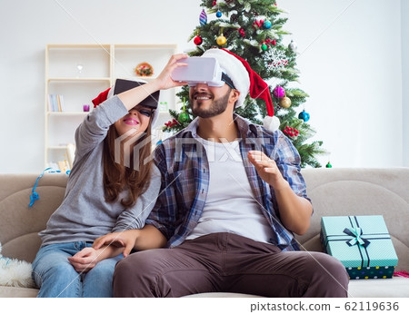 Happy family using virtual reality VR glasses during christmas 62119636