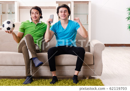 Friends watching football at home 62119703