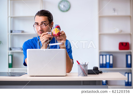 Young male doctor working in the clinic 62120356