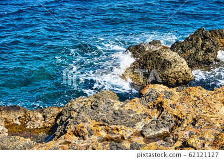 View on Rock on Nisyros island covered by orange 62121127