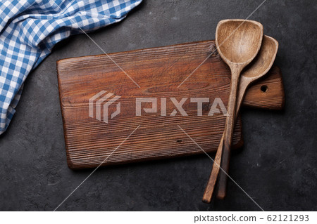 Kitchen table with utensils, cutting board and 62121293