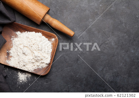 Rolling pin on kitchen table Rolling pin on kitchen table 62121302