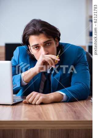 Young man having problems with narcotics at workplace Young man having problems with narcotics at workplace 62121783