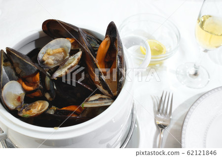 Pot of mussels and clams on a table isolated 62121846
