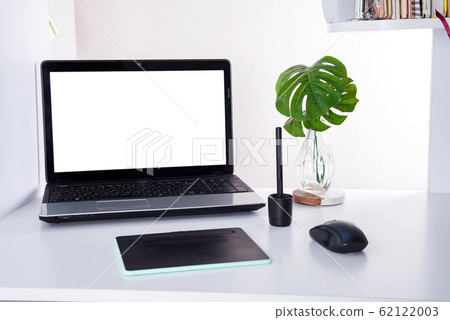 Workplace with notebook laptop and palm leaves. Comfortable work table in home or office 62122003