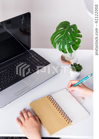 School boy using laptop on a table at home, Schoolboy doing homework 62122008