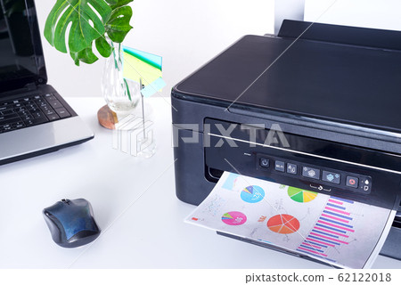 Printer and paper isolated on a white home table 62122018