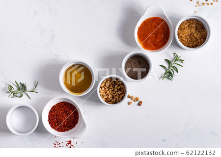 Set of different spices for sauces on stone background. 62122132