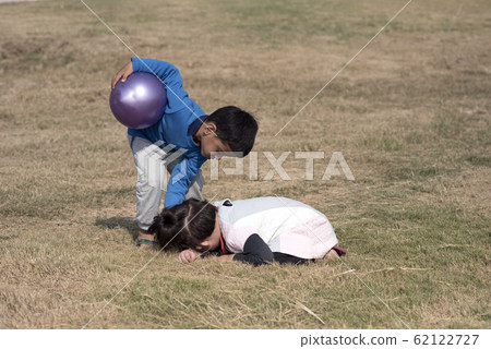 Little girl hiding her face. 62122727