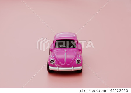 Miniature pink toy car on pink background. Minimal 62122990