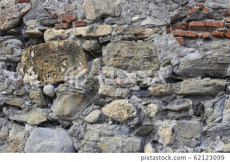 Very old wall from stones of various shapes and 62123099