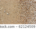 Brown beach texture with small rocks and sand 62124509