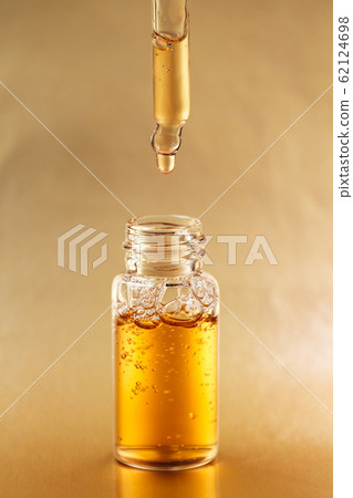 Bottle of cosmetic oil with pipette 62124698