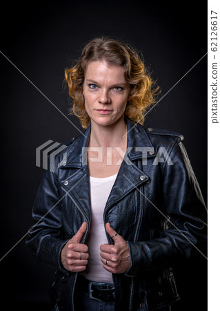 Portrait of young attractive woman on dark background Portrait of young attractive woman on dark background 62126617