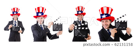 Man with USA hat and movie board isolated on white Man with USA hat and movie board isolated on white 62131158