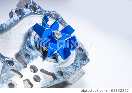 New metal automobile pump for cooling the engine of a water pump on a gray background. The concept of new spare parts for the car engine New metal automobile pump for cooling the engine of a water pump on a gray background. The concept of new spare parts for the car engine 62132262