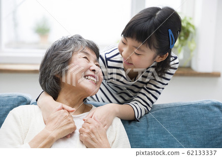 Grandchildren snuggle up with grandmother Grandchildren snuggle up with grandmother 62133337