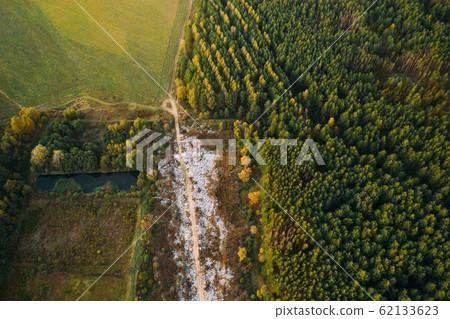 Aerial View Of Domestic Garbage Near Green Forest. Bird's-eye View Of Junk. Domestic Waste In Landfill Junkyard. Eco Concept Garbage Disaster From Ecological Pollution Of Environment 62133623