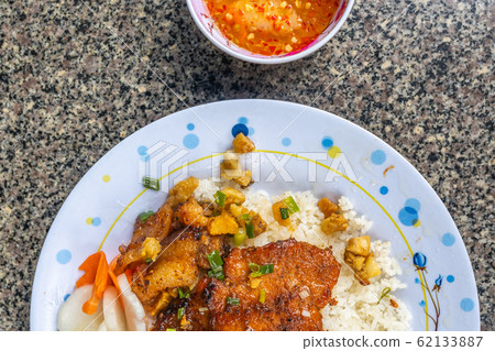 Tasty homemade Vietnamese style pork chop rice with chili sauce Tasty homemade Vietnamese style pork chop rice with chili sauce 62133887