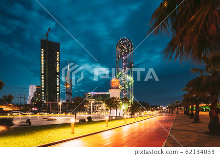 Batumi, Adjara, Georgia. Illuminated Alphabet Tower At Promenade Near Miracle Park, Amusement City Park On Blue Evening Or Night Sky Background. Modern Urban Architecture 62134033