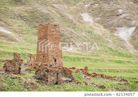 Ancient Old Stone Watchtower On Mountain Background In Chetoyta Or Zakagori Village, Kazbegi District, Mtskheta-Mtianeti Region, Georgia. Spring, Summer Season. Truso Gorge. 62134057