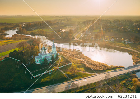 Krupets, Dobrush District, Gomel Region, Belarus. Aerial View Of Old Wooden Orthodox Church Of The Holy Trinity At Sunny Autumn Day Krupets, Dobrush District, Gomel Region, Belarus. Aerial View Of Old Wooden Orthodox Church Of The Holy Trinity At Sunny Autumn Day 62134281