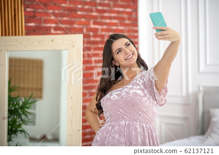 Young plus-size woman making selfie and looking amazing Young plus-size woman making selfie and looking amazing 62137121