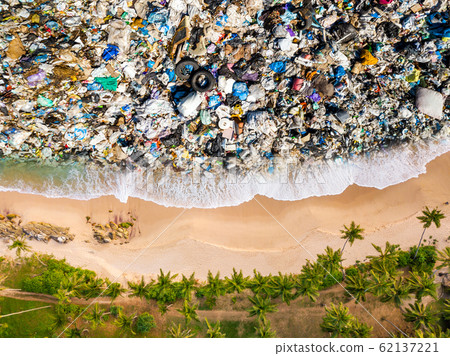 Tropical beach and trash in the water. Ocean pollution concept with plastic 62137221