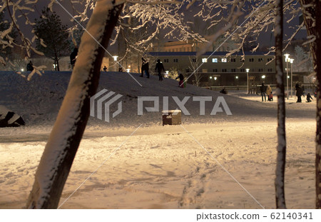 Kids walking in the park with fresh snow after a snowfall 62140341