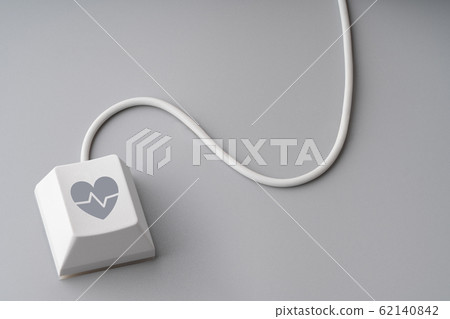 Medical icon on keyboard with cable mouse Medical icon on keyboard with cable mouse 62140842