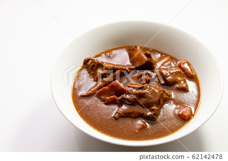 Beef tongue stew. (White plate, white background) Beef tongue stew. (White plate, white background) 62142478