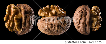 Set of half opened walnuts with kernel isolated on a black background Set of half opened walnuts with kernel isolated on a black background 62142759