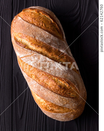 Top view photo of fresh baked bread on black wooden table 62142760
