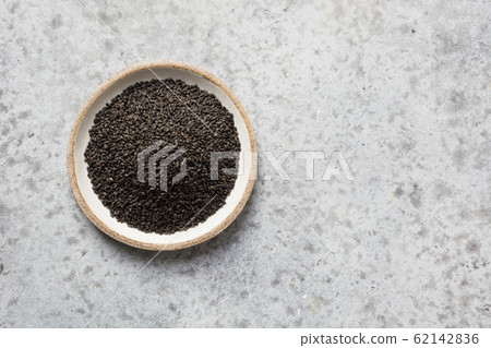 Basil or grain seeds in bowl isolated on grey Basil or grain seeds in bowl isolated on grey 62142836