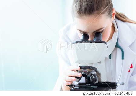 medical doctor scientist working women looking at microscope medical doctor scientist working women looking at microscope 62143493