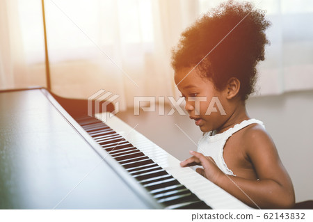 children girl playing piano looking exciting happy and enjoy with music instrument 62143832