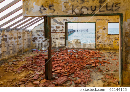 Pier view through derelict house by the beach Pier view through derelict house by the beach 62144123