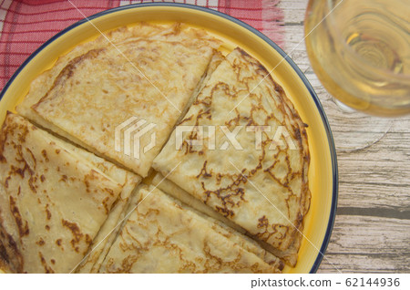 Traditional Russian food, delicious pancakes on a plate, stacked stack. The carnival and seeing the Russian winter, view from above Traditional Russian food, delicious pancakes on a plate, stacked stack. The carnival and seeing the Russian winter, view from above 62144936