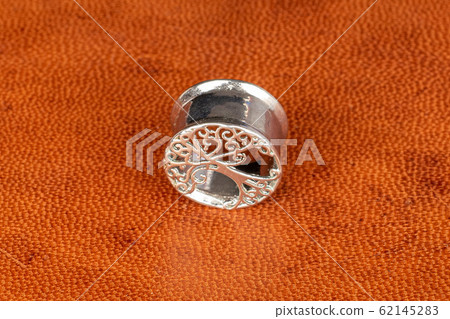 Stylish ear plug on cognac leather Stylish ear plug on cognac leather 62145283